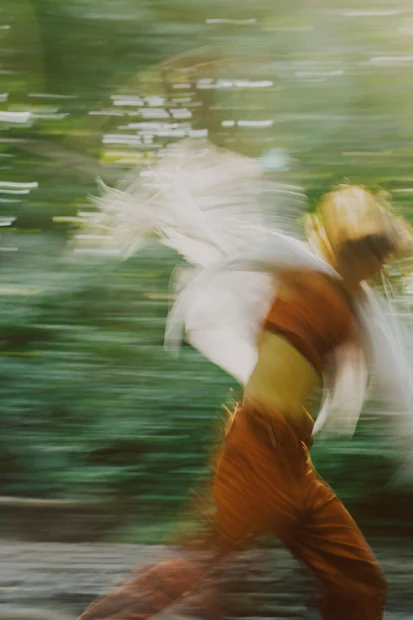 A motion-blurred photograph of a person outdoors