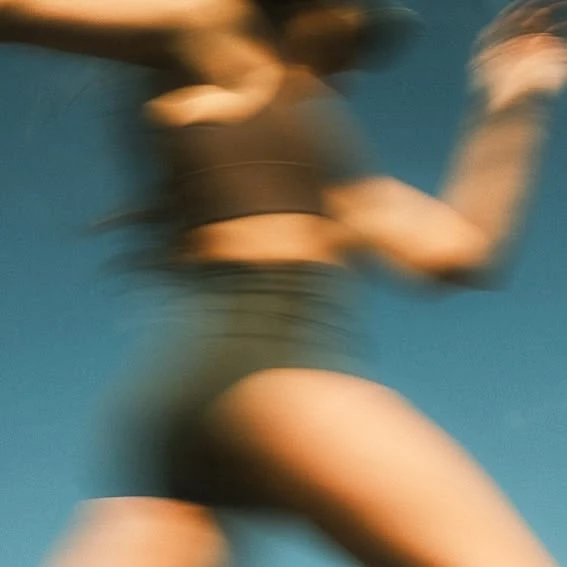 A motion-blurred photograph of a runner